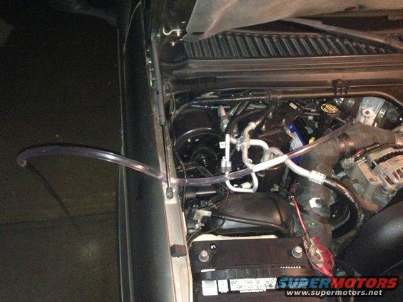 2003 Ford Excursion engine bay with clear tubing connected to the engine