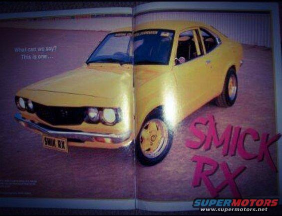 Yellow 1973 Mazda RX-3 coupe, 3q front view. "SMICK RX" text on floor