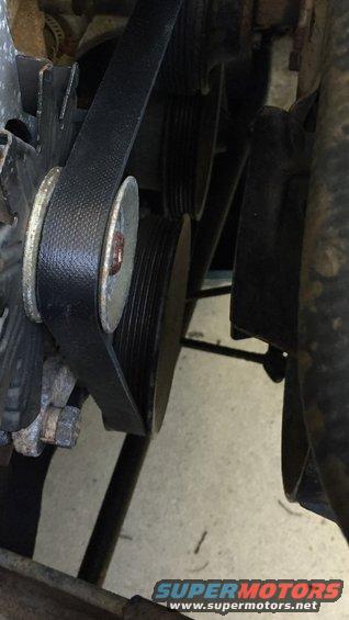 Engine belt wrapped around pulleys and alternator