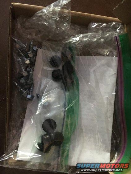 Box containing plastic bags with screws, bolts, and other hardware