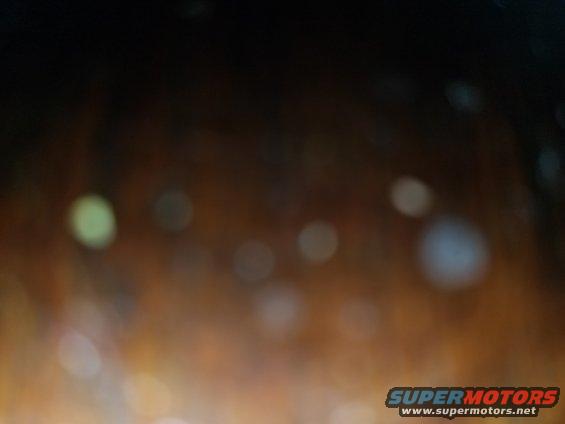 Bokeh lights in a dark interior, with Supermotors logo at bottom right