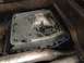 1986 Ford Bronco - Underside view of a vehicle's oil pan, showing a blue gasket and signs of wear.