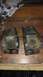 1996 Ford Bronco - Two heavily rusted metal brackets are shown, each with two visible bolt holes.