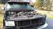 1996 Ford Bronco - Front view of a 1996 Ford Bronco with the hood open, revealing the engine and surrounding components.