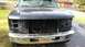 1996 Ford Bronco - The front end of a Ford truck is shown with the grille and headlights removed, exposing the radiator and other components.