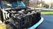 1996 Ford Bronco - The front end of a truck is shown with its hood and grille removed, revealing the engine and radiator components.