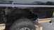 1996 Ford Bronco - This SUV's rear quarter panel shows significant rust and damage, with a section cut out.