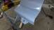 1996 Ford Bronco - A car door panel is being prepped for paint in a workshop environment.