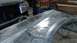1996 Ford Bronco - A car fender is shown with metal pins inserted, likely for bodywork or repair.