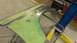 1996 Ford Bronco - A car fender, prepped with green primer and exposed metal, is held by a lift in a workshop.
