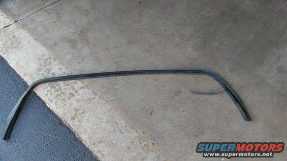 Curved black rubber seal on concrete