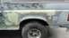 1996 Ford Bronco - The vehicle is undergoing body work, with visible patches of primer and filler on its side.