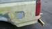 1996 Ford Bronco - This vehicle's rear quarter panel is covered in body filler and primer, obscuring its original year and model.