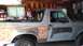 1996 Ford Bronco - This Ford Bronco is undergoing bodywork, showing primer and exposed metal on its side.