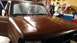1996 Ford Bronco - Front view of a brown Ford Bronco, likely undergoing restoration, with garage items in the background.