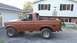 1996 Ford Bronco - This lifted Ford Bronco, with its top removed, is parked in front of a house and garage.