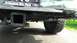 1996 Ford Bronco - Close-up of a trailer hitch and backup camera mounted on the rear bumper of a vehicle.