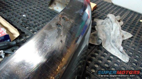 chrome bumper with some dents and scratches, rag on the side