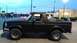 1996 Ford Bronco - Side view of a black 1996 Ford Bronco with aftermarket wheels.