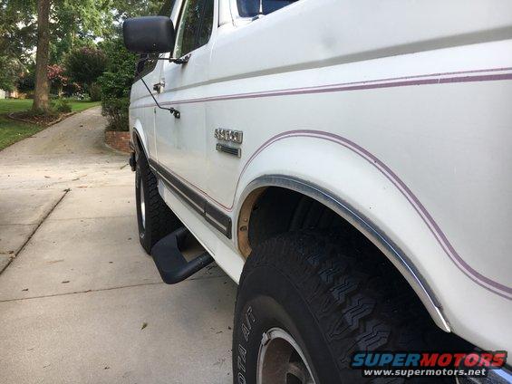 White 1988 Ford Bronco side view with purple pinstripes