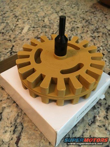 Yellow decal eraser wheel with black adapter on white box