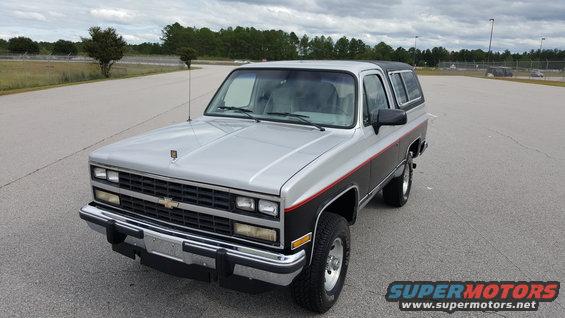 Silver and black Chevrolet K5 Blazer with red pinstripes, front 3/4 view