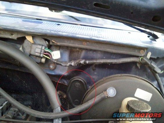 close-up of engine bay with wiring and brake booster