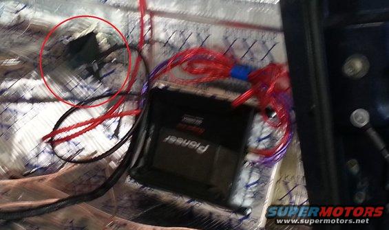 Pioneer stereo amplifier with red and blue wiring, installed over sound deadening material