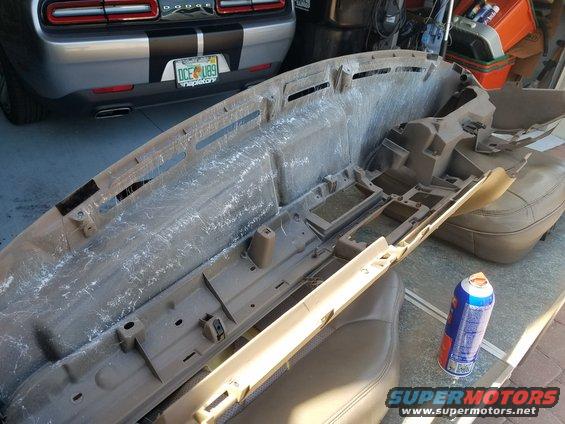 Disassembled dashboard and car seat with a can of spray