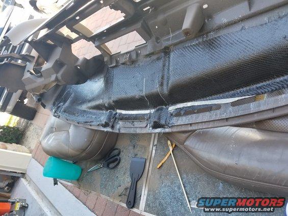 Dashboard assembly with carbon fiber reinforcement and repair tools, including scissors and a scraper