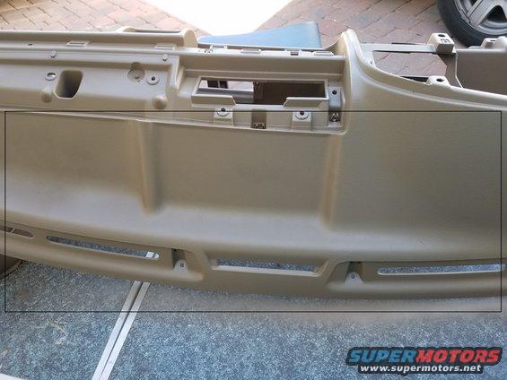 Tan dashboard part with vents and openings