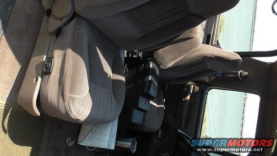 Gray fabric seats and center console of a vehicle interior