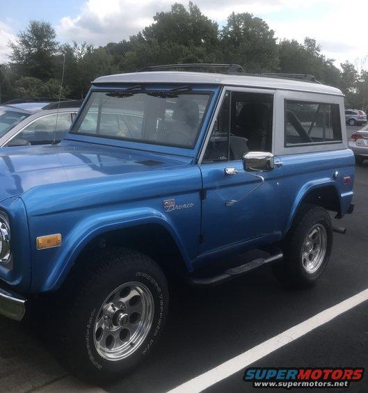 Blue 1974 Ford Bronco parked outdoors, showing its side and front quarter