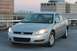 2007 Chevrolet Impala - Silver sedan parked on a rooftop with buildings in the background.