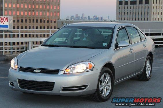 Silver Chevrolet sedan parked on a rooftop, front quarter view