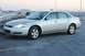 2007 Chevrolet Impala - A silver 2007 Chevrolet Impala is parked on a rooftop with a city skyline in the background.