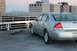2007 Chevrolet Impala - Silver sedan parked on a rooftop with a city skyline in the distance.