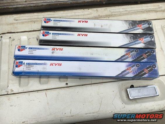 Four boxes of Carquest KYB Performance Plus shock absorbers stacked in a truck bed