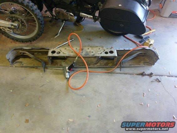 Rear bumper assembly with air impact wrench and orange hose