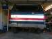 1988 Ford Bronco - Rear view of a 1988 Ford Bronco, a custom metal bumper and distinctive red, white, and silver tailgate stripe.