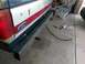 1988 Ford Bronco - Custom steel rear bumper installation on a Ford Bronco, with tools and a cooler visible.