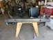 1988 Ford Bronco - A fabricated metal bumper is displayed on wooden sawhorses in a garage setting.