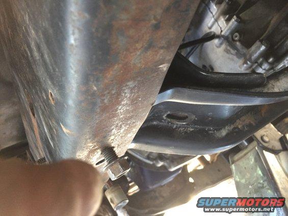 Close-up of a bolt and nut on a vehicle's underbody