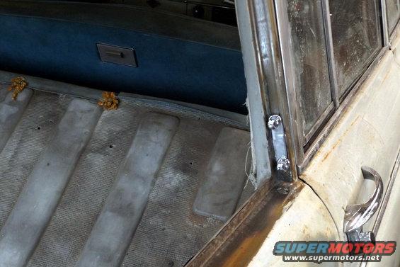 Interior view of a vintage car's passenger side door frame and seat