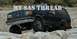 1988 Ford Bronco - This dark blue Ford Bronco navigates a rocky trail, its off-road capabilities.