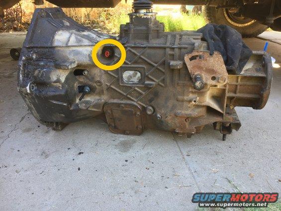 Transmission with yellow circle highlighting a red cap