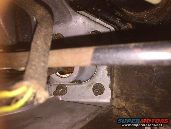 close-up of some metal brackets and a cable bundle under a vehicle