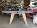 1988 Ford Bronco - A fabricated metal bumper with a hitch receiver sits on sawhorses in a cluttered garage.