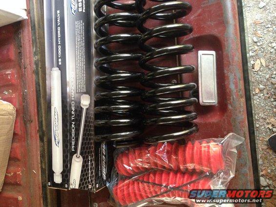 New shocks and springs for a vehicle, with red dust boots