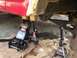 1986 Ford Bronco - Vehicle suspension and frame components are elevated on jacks and stands for maintenance.